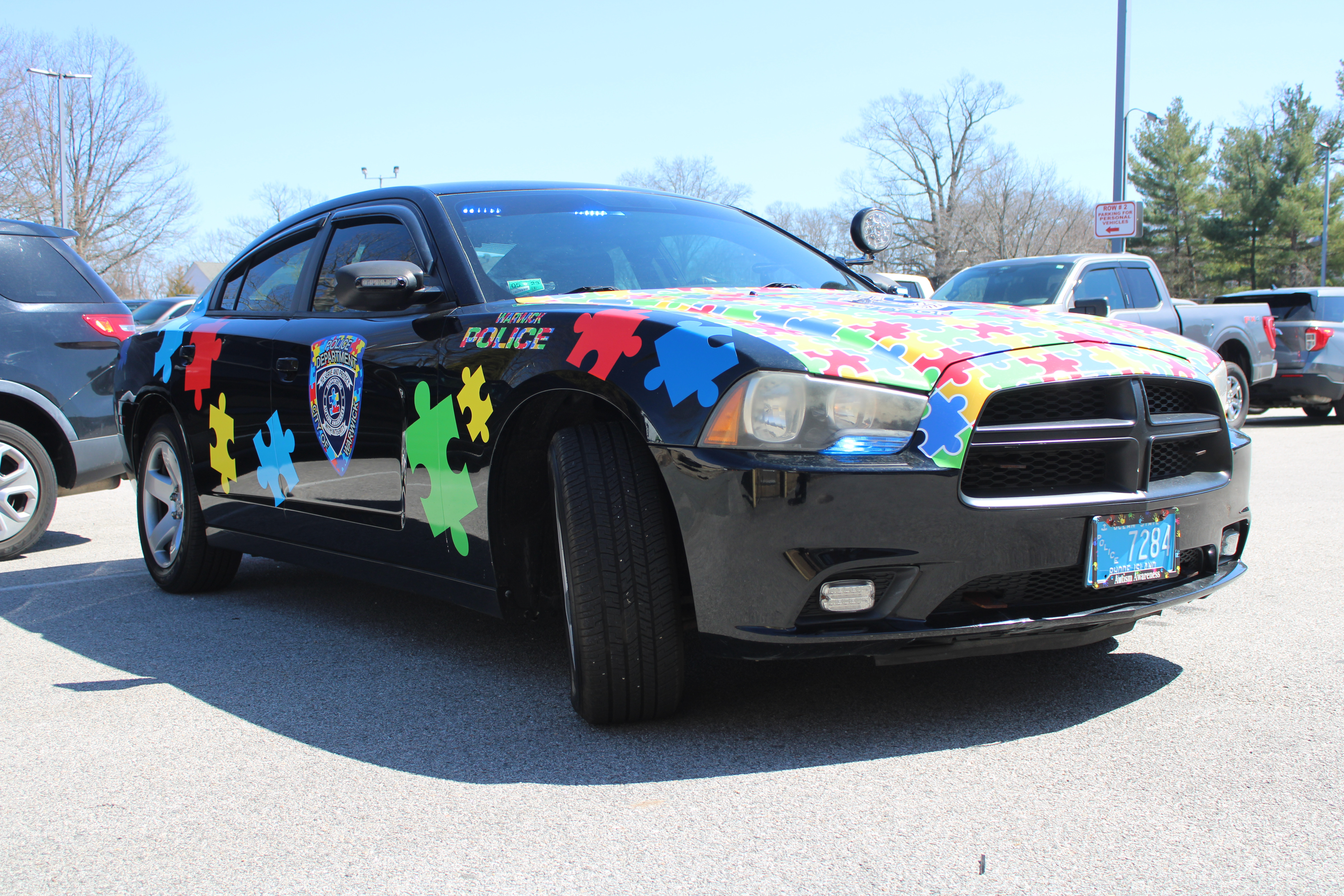 A photo  of Warwick Police
            Autism Awareness Unit, a 2011 Dodge Charger             taken by @riemergencyvehicles